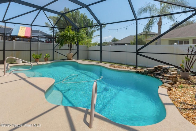 view of swimming pool featuring a lanai and a patio