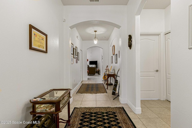 corridor with light tile patterned floors