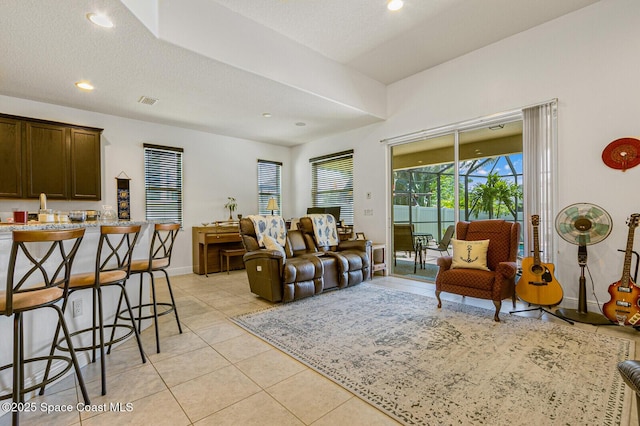 tiled living room with a textured ceiling