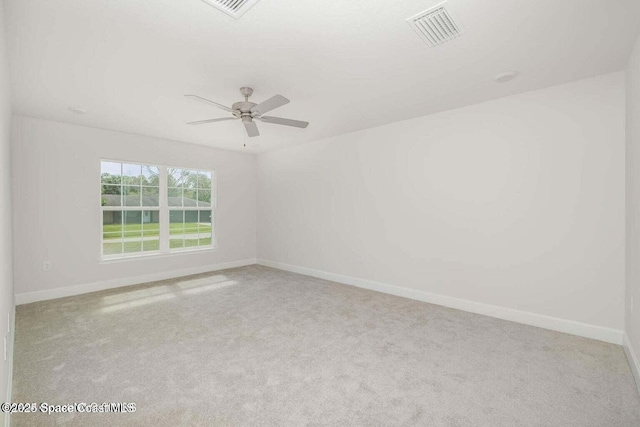 unfurnished room featuring carpet floors, visible vents, and baseboards