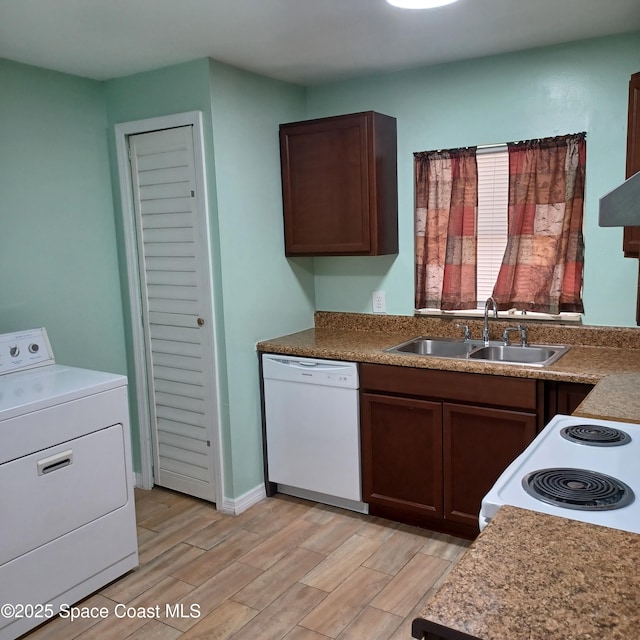 kitchen with dark brown cabinetry, sink, washer / dryer, and white appliances