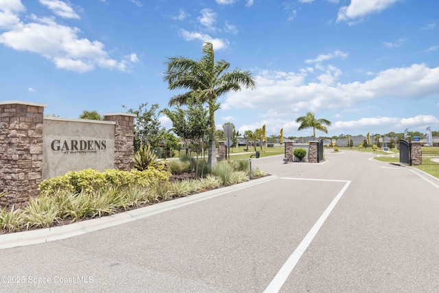 416 Glaspell Cir SE, Palm Bay, FL 32909 - view of asphalt street with curbs and a gated entry