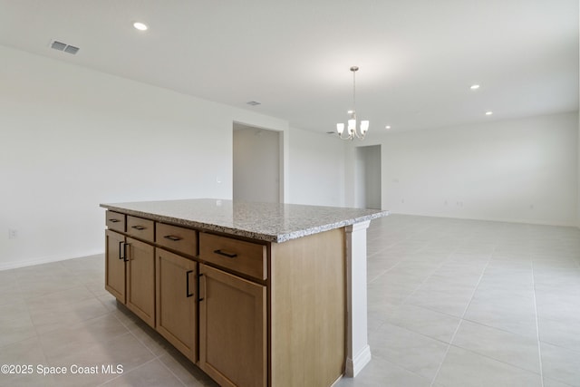 416 Glaspell Cir SE, Palm Bay, FL 32909 - kitchen with a kitchen island, light tile patterned floors, a chandelier, light stone countertops, and recessed lighting