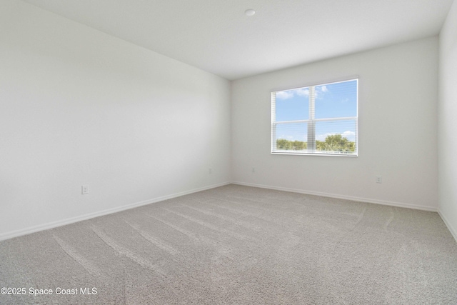 416 Glaspell Cir SE, Palm Bay, FL 32909 - spare room featuring light carpet and baseboards
