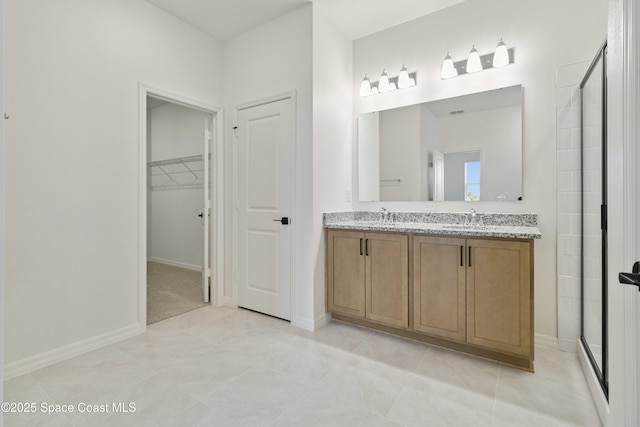 416 Glaspell Cir SE, Palm Bay, FL 32909 - full bathroom with double vanity, tiled shower, a walk in closet, and tile patterned flooring
