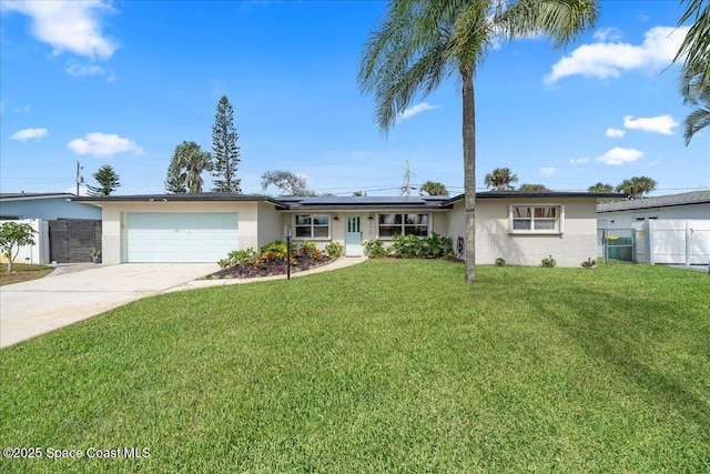 ranch-style house featuring a garage, solar panels, fence, driveway, and a front yard