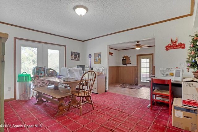 dining room with ornamental molding, french doors, and a textured ceiling