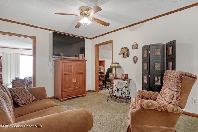 living room with light carpet, ceiling fan, ornamental molding, and a textured ceiling