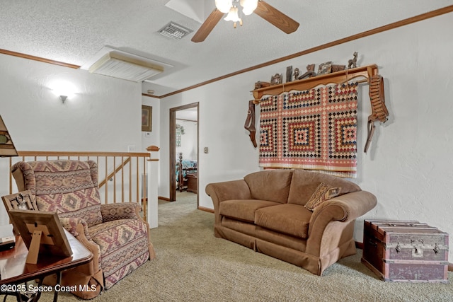 carpeted living room featuring ceiling fan, ornamental molding, and a textured ceiling