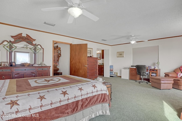 carpeted bedroom featuring ornamental molding, ceiling fan, and a textured ceiling