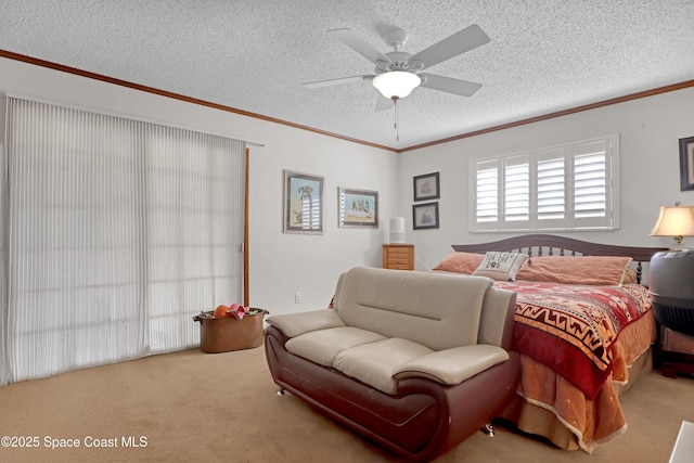 bedroom featuring ornamental molding, carpet, ceiling fan, and a textured ceiling