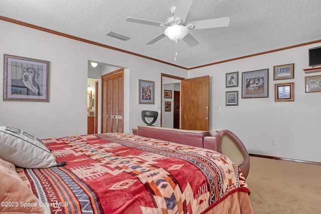 bedroom featuring a closet, ornamental molding, carpet, and a textured ceiling