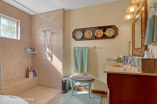 bathroom with vanity and a tile shower