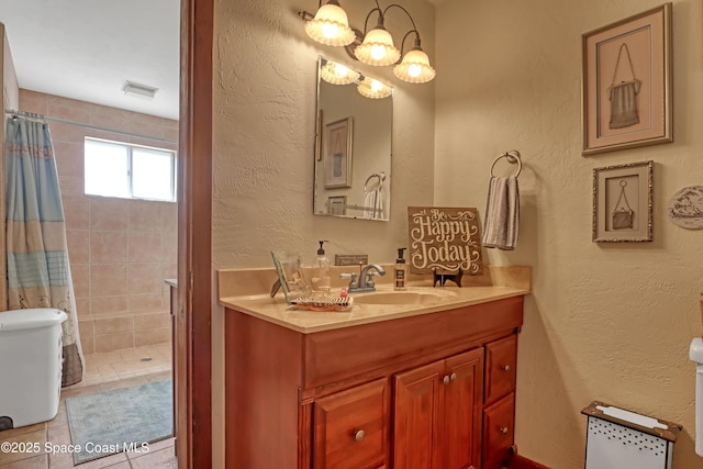 bathroom with a shower with curtain, tile patterned floors, vanity, and a notable chandelier