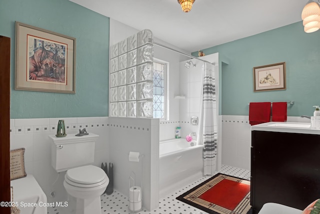 bathroom featuring tile walls, vanity, and toilet