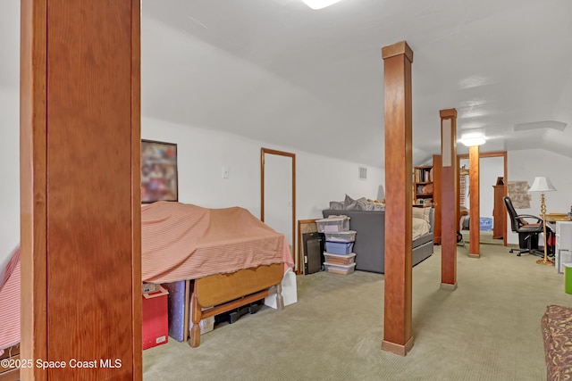 carpeted bedroom with lofted ceiling