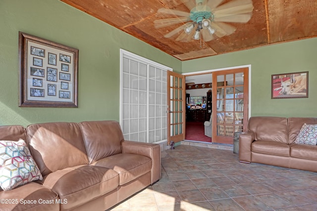 living room with tile patterned floors, wooden ceiling, french doors, and ceiling fan