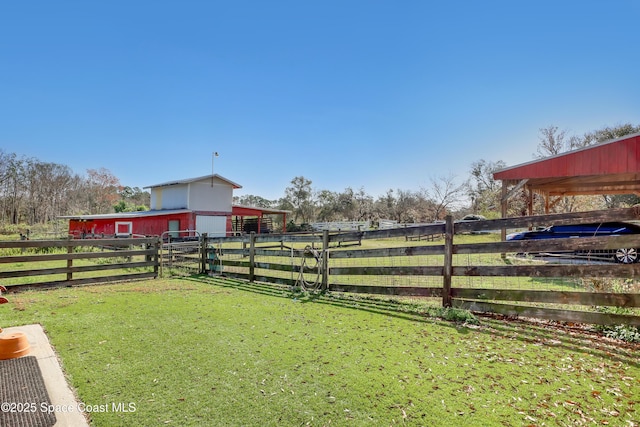 view of yard with an outbuilding and a rural view