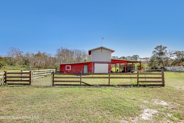 view of outbuilding with a rural view and a lawn