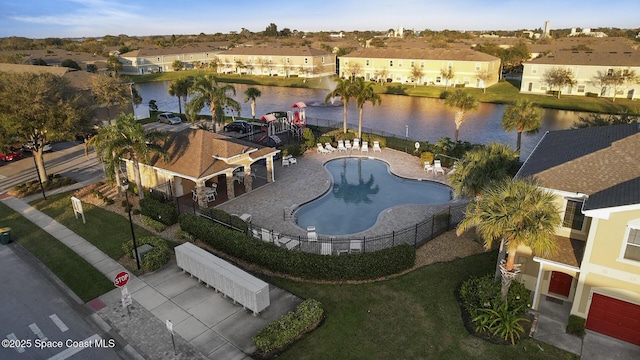 birds eye view of property with a water view and a residential view