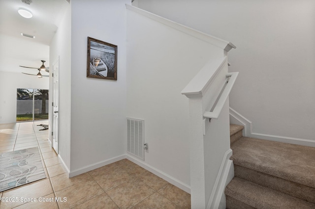 stairs with baseboards, visible vents, and tile patterned flooring