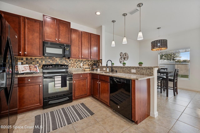 kitchen featuring pendant lighting, visible vents, a sink, a peninsula, and black appliances