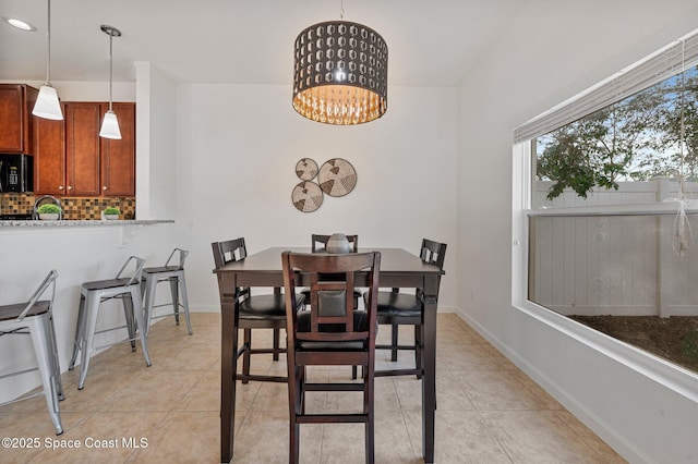 dining area with light tile patterned floors, recessed lighting, a chandelier, and baseboards