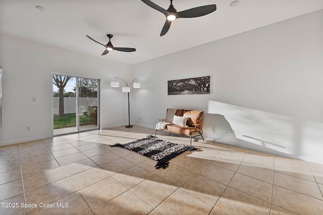 sitting room with light tile patterned floors, baseboards, and a ceiling fan