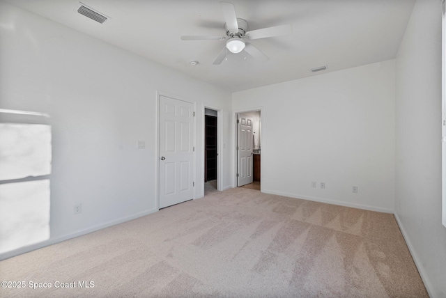 unfurnished bedroom with light colored carpet, visible vents, and baseboards