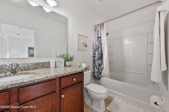 bathroom featuring shower / bath combo, vanity, toilet, and tile patterned floors