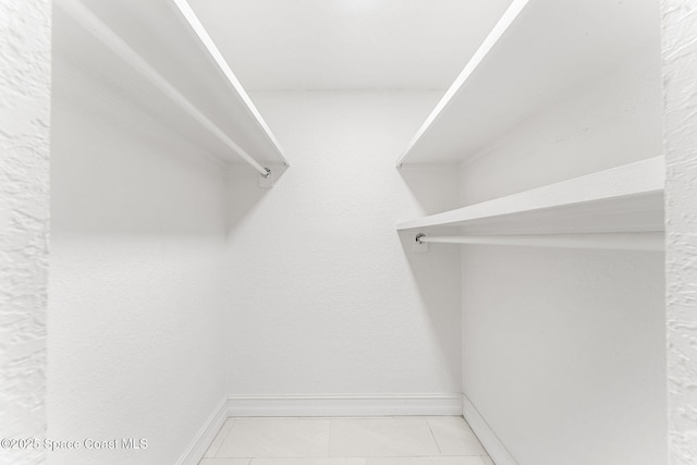 walk in closet featuring light tile patterned floors