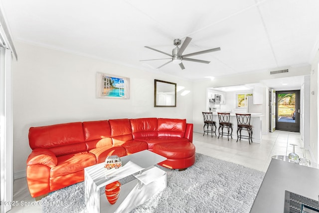 living room featuring ornamental molding and ceiling fan