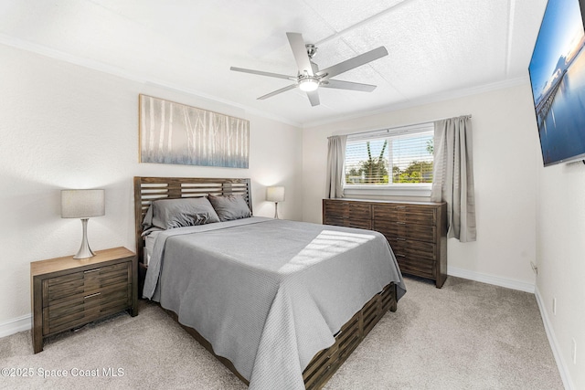 carpeted bedroom featuring crown molding and ceiling fan
