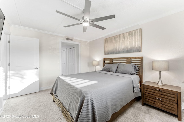 carpeted bedroom featuring crown molding and ceiling fan