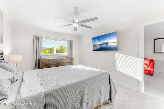 bedroom with ceiling fan, ornamental molding, and carpet flooring