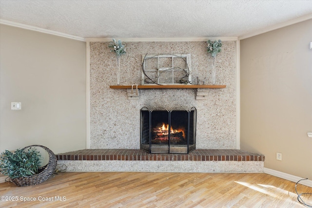 details with crown molding, a textured ceiling, wood finished floors, a warm lit fireplace, and baseboards