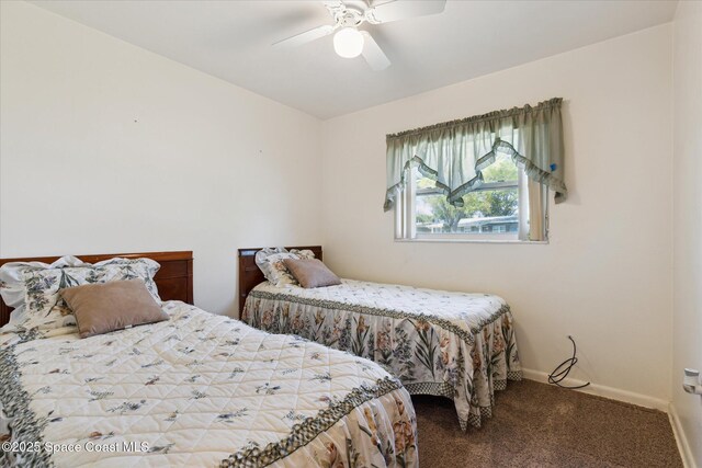 carpeted bedroom with a ceiling fan and baseboards