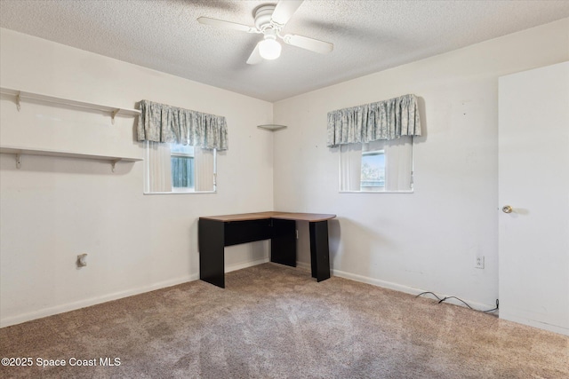 interior space with a textured ceiling, baseboards, and a ceiling fan