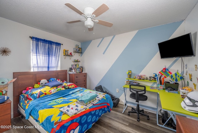 bedroom with ceiling fan, hardwood / wood-style floors, and a textured ceiling