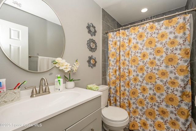 bathroom featuring vanity, toilet, and a shower with shower curtain