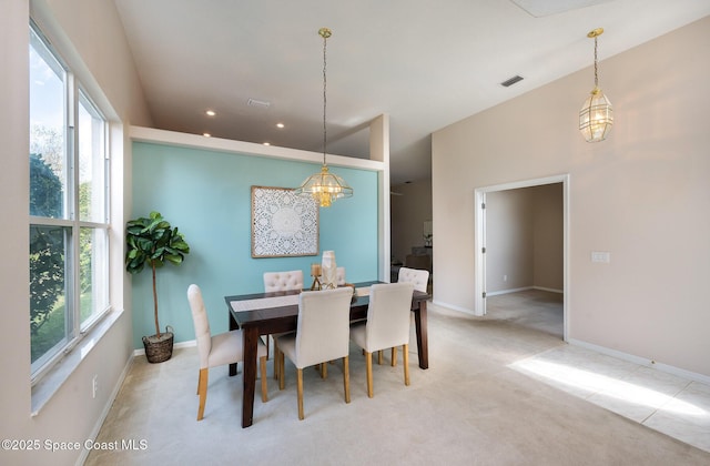 carpeted dining area with plenty of natural light