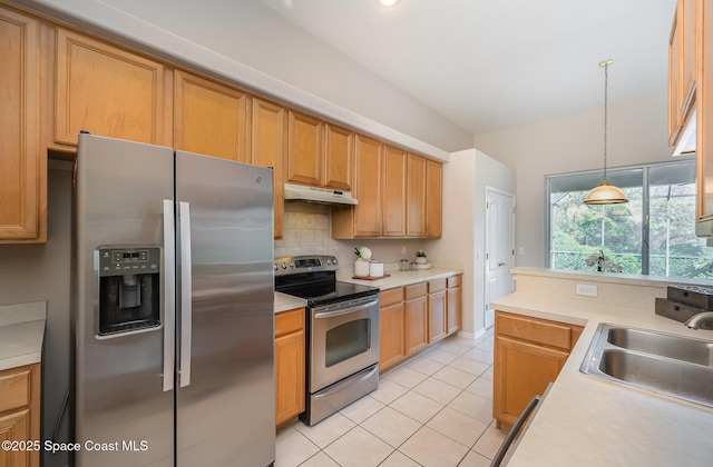 kitchen with light tile patterned flooring, appliances with stainless steel finishes, pendant lighting, sink, and backsplash