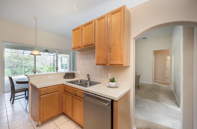 kitchen with light tile patterned flooring, sink, tasteful backsplash, dishwasher, and pendant lighting