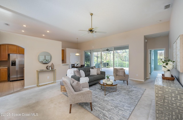 living room featuring light colored carpet and ceiling fan