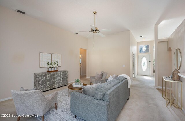 living room featuring light colored carpet and ceiling fan