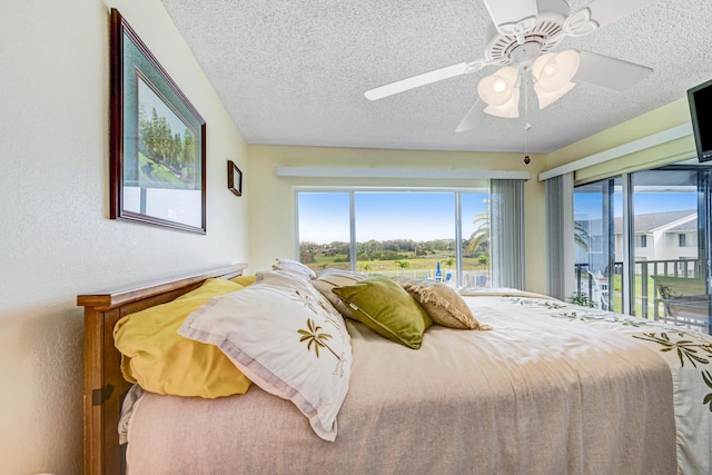 bedroom featuring multiple windows, ceiling fan, access to exterior, and a textured ceiling