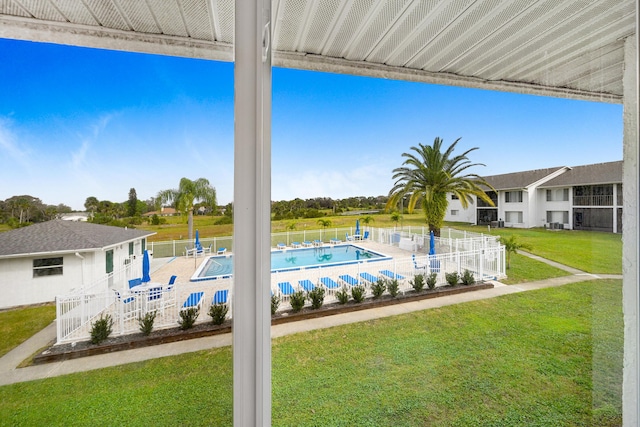 view of pool with a lawn