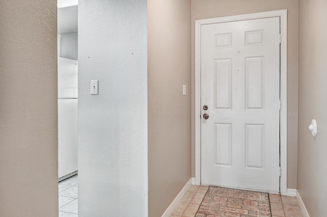 doorway to outside featuring light tile patterned flooring