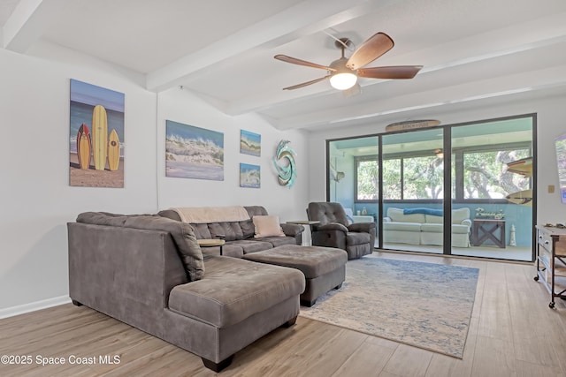 living room featuring ceiling fan, light hardwood / wood-style flooring, and beamed ceiling