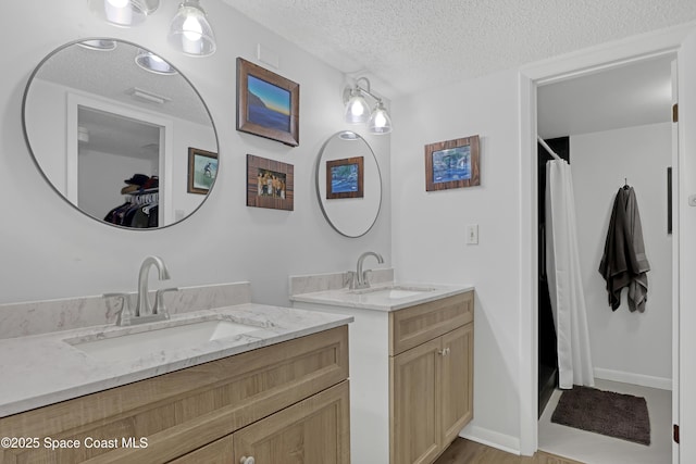 bathroom featuring vanity and a textured ceiling